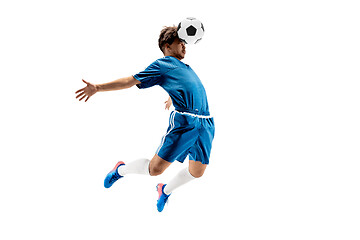 Image showing Young boy with soccer ball doing flying kick