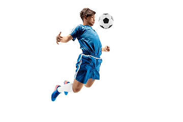 Image showing Young boy with soccer ball doing flying kick