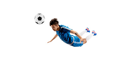 Image showing Young boy with soccer ball doing flying kick