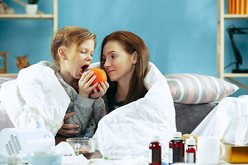 Image showing Sick woman with daughter at home. The ill family.