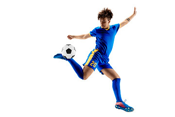 Image showing Young boy with soccer ball doing flying kick