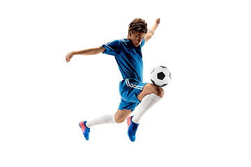 Image showing Young boy with soccer ball doing flying kick