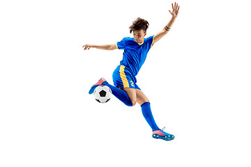 Image showing Young boy with soccer ball doing flying kick