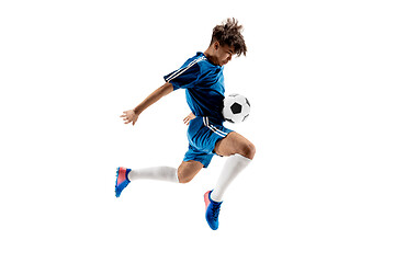 Image showing Young boy with soccer ball doing flying kick