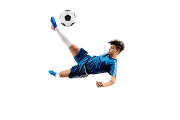 Image showing Young boy with soccer ball doing flying kick