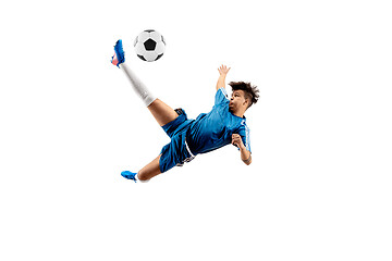 Image showing Young boy with soccer ball doing flying kick