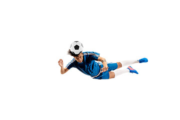 Image showing Young boy with soccer ball doing flying kick