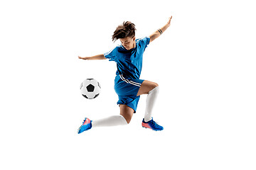 Image showing Young boy with soccer ball doing flying kick