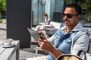 Image showing man with tablet pc and coffee at street cafe