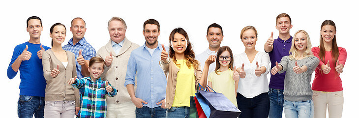 Image showing woman with shopping bags and people show thumbs up