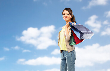 Image showing happy asian woman with shopping bags