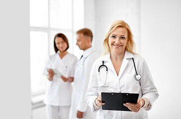 Image showing smiling doctor with clipboard and stethoscope