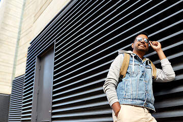 Image showing indian man in sunglasses with backpack on street