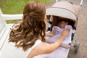 Image showing mother with child in stroller at summer park