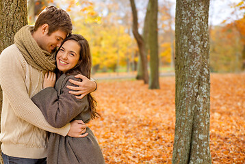 Image showing smiling couple hugging in autumn park