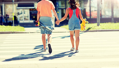 Image showing teenage couple with skateboards at city crosswalk