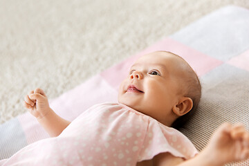 Image showing sweet baby girl lying on knitted blanket