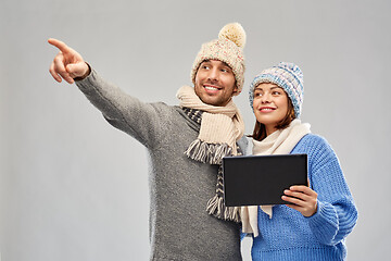 Image showing couple in winter clothes with tablet computer