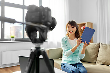 Image showing asian female blogger making video review of book