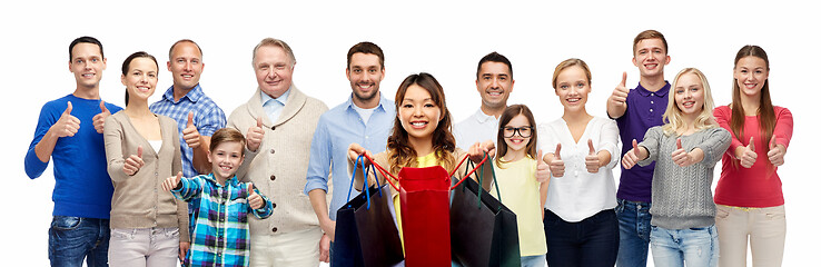 Image showing woman with shopping bags and people show thumbs up