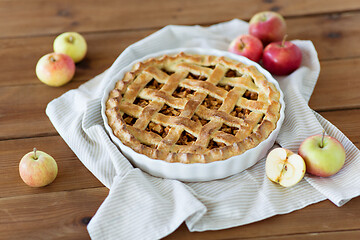 Image showing apple pie in baking mold on wooden table