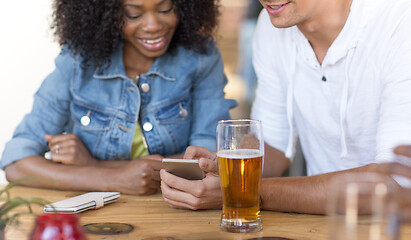 Image showing couple with smartphone and beer at bar