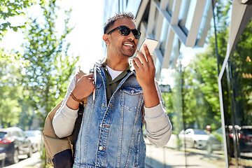 Image showing man recorving voice message on smartphone in city