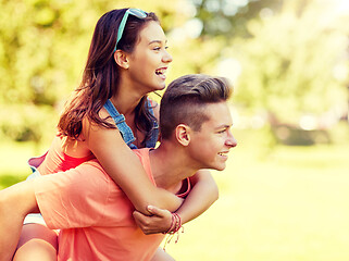 Image showing happy teenage couple having fun at summer park