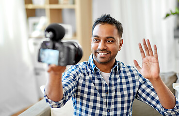 Image showing male video blogger with camera blogging at home