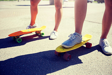 Image showing teenage couple riding skateboards on city street