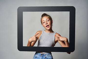 Image showing Cute teen girl giving some attitude posing pointing at herself