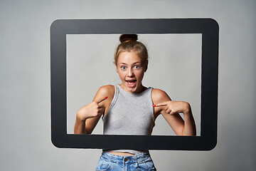 Image showing Cute teen girl giving some attitude posing pointing at herself