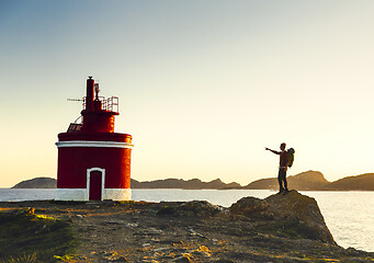 Image showing Man exploring the coast line at sunset