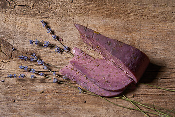 Image showing Lavender cheese with bunch of fresh lavender flowers on rough wooden planks