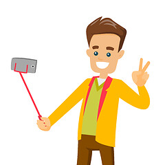 Image showing A white man making selfie on his cellphone with a selfie stick.