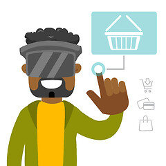 Image showing A black man in virtual reality headset doing online shopping.