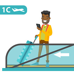 Image showing A traveller in an airport with a smartphone and a suitcase.