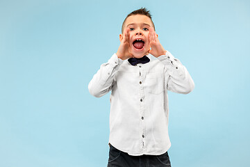 Image showing Isolated on pink young casual boy shouting at studio