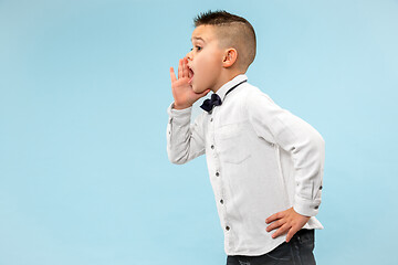 Image showing Isolated on pink young casual boy shouting at studio