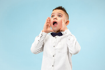 Image showing Isolated on pink young casual boy shouting at studio