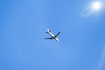 Image showing blue sky with plane and sun