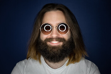 Image showing bearded young man with long hair and sunglasses