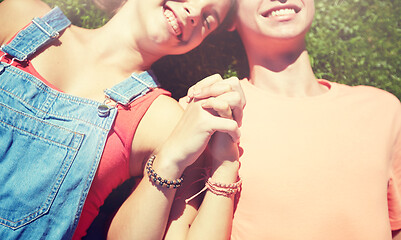 Image showing happy teenage couple lying on grass at summer