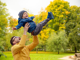 Image showing father with son playing and having fun in autumn