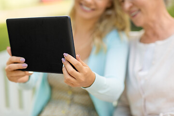 Image showing adult daughter and senior mother with tablet pc