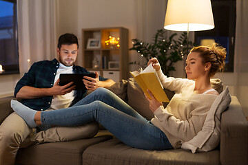 Image showing couple with tablet computer and book at home