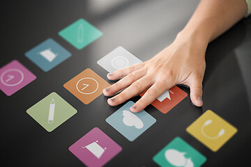 Image showing hand using interactive panel with app icons on it