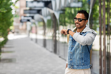 Image showing indian man recording voice message by smart watch