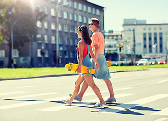 Image showing teenage couple with skateboards on city crosswalk