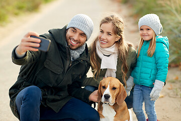 Image showing happy family with dog taking selfie in autumn